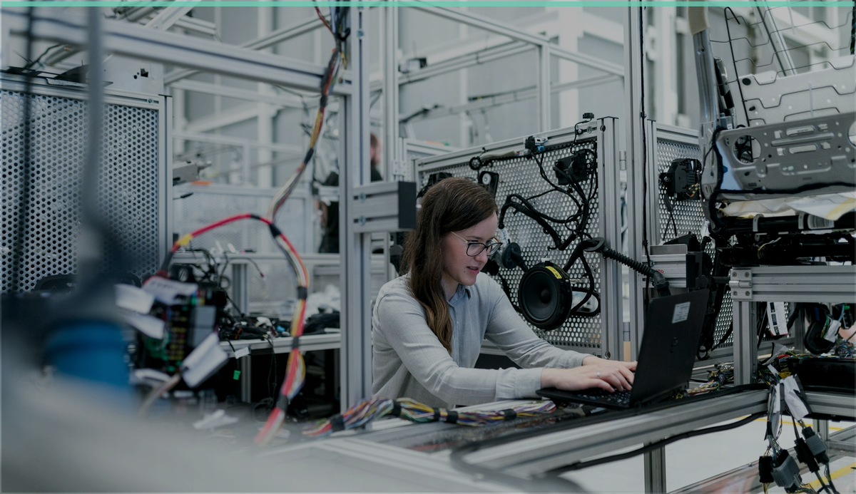 Engineer using a laptop in a technical environment for endpoint coverage review